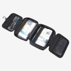 Compact black toiletry bag open to show organized compartments with travel-sized bottles and mesh pockets