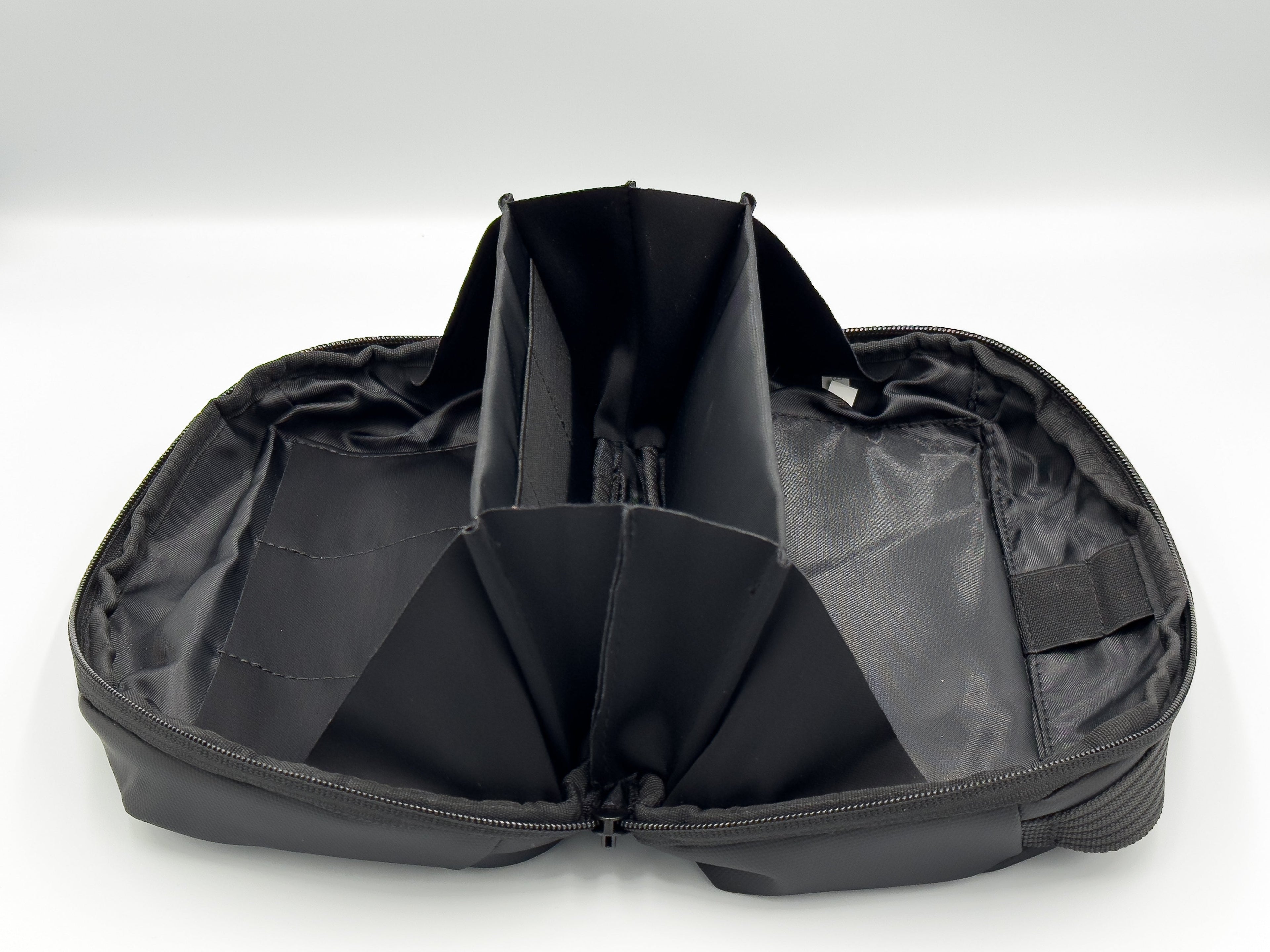 Black ESSENTIA Bag travel organizer with multiple compartments, water-resistant and lightweight design for tech and accessory storage.