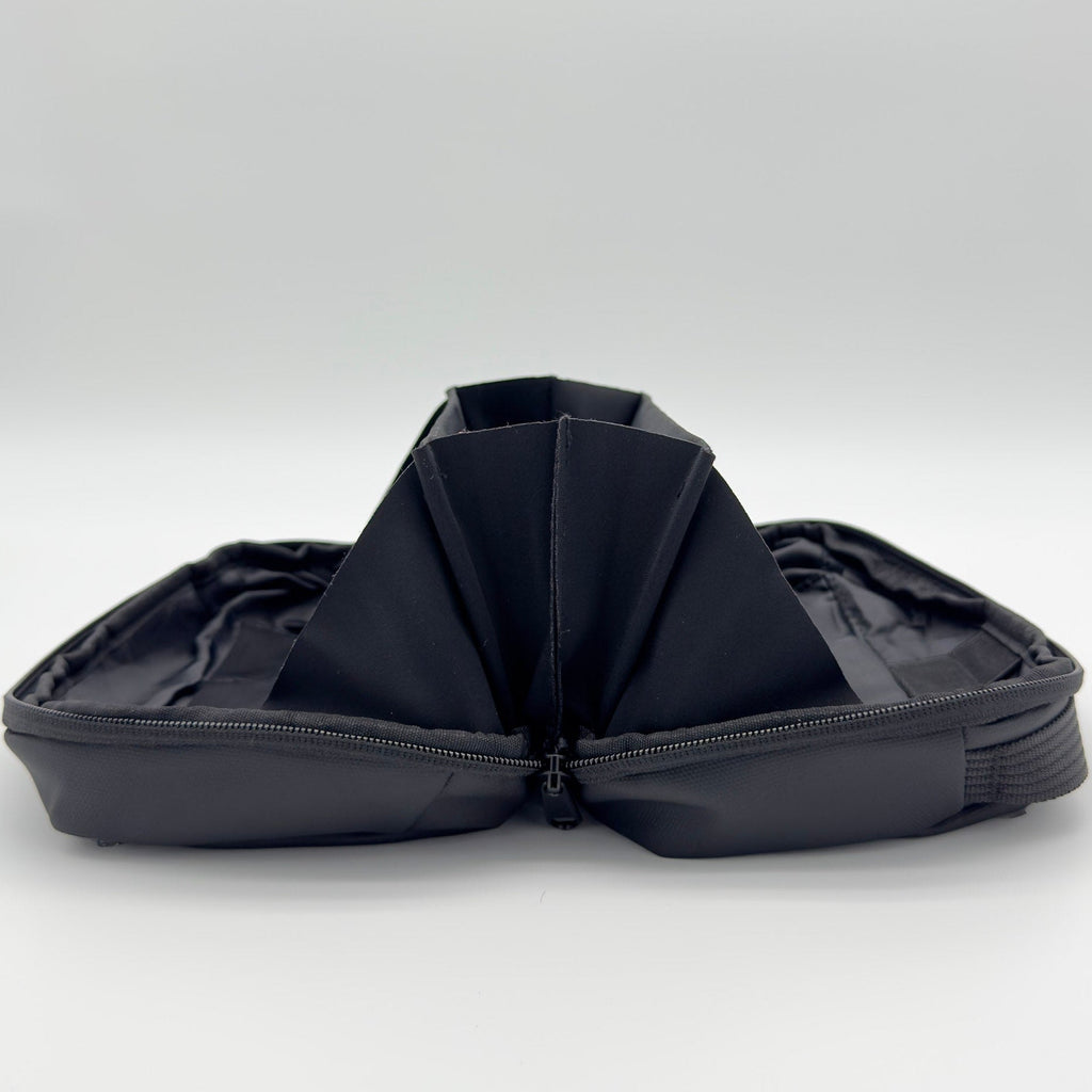 Black folded travel bag on a white background
